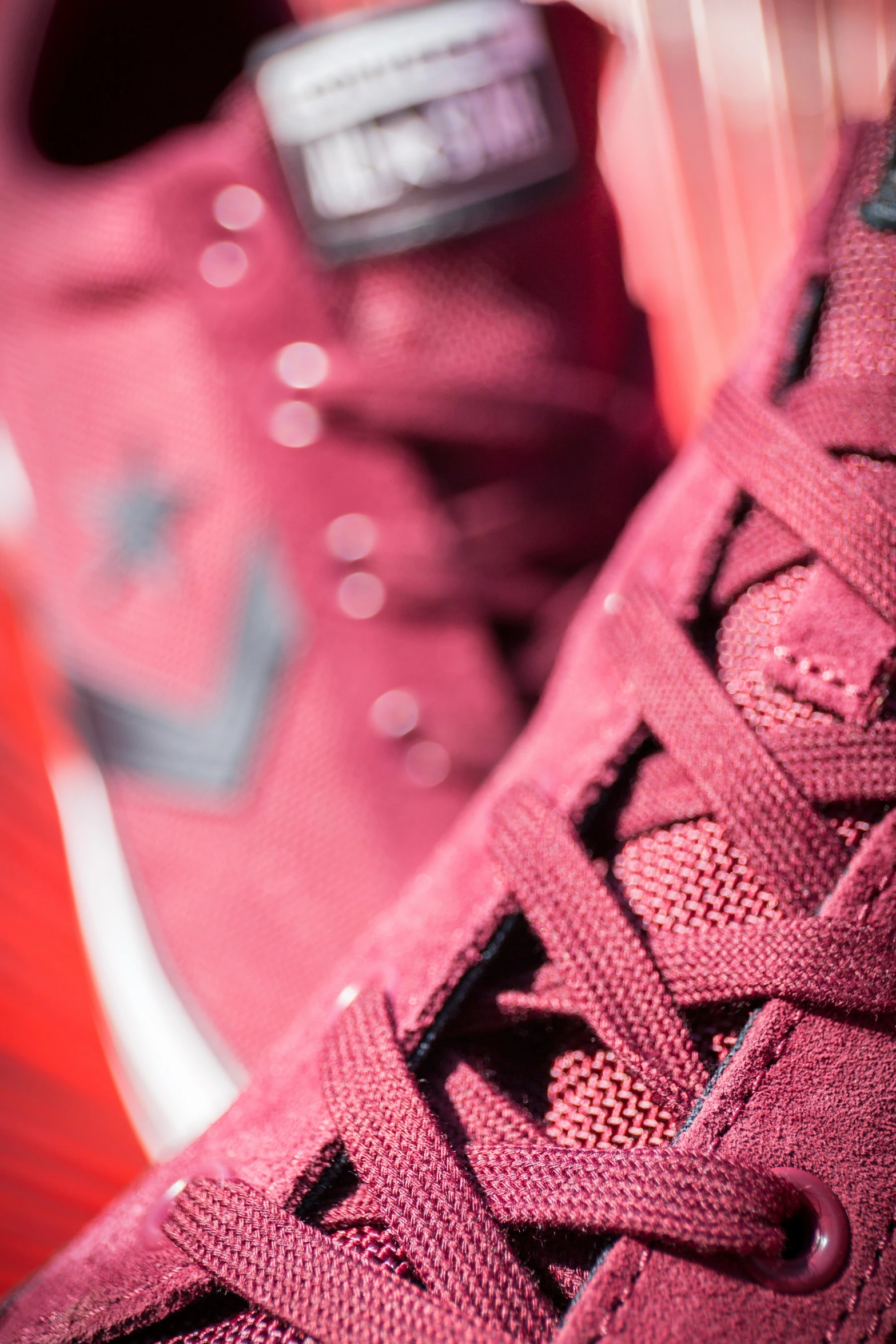 sneakers with black and pink laces on a table