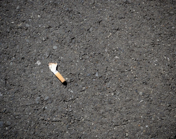 cigarette on the ground with a small piece of lighter