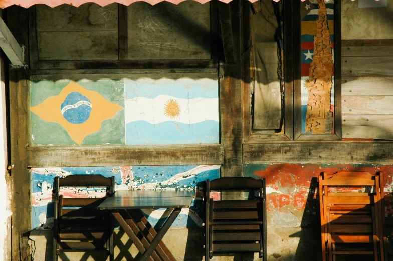 three chairs sit on the floor near a table with two boards