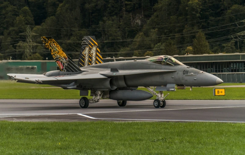 a fighter jet is taking off on a runway