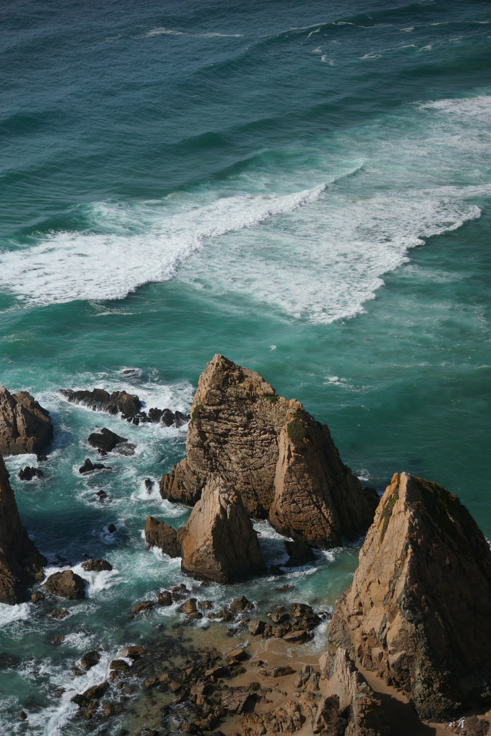 a person riding on a surf board over a small cliff