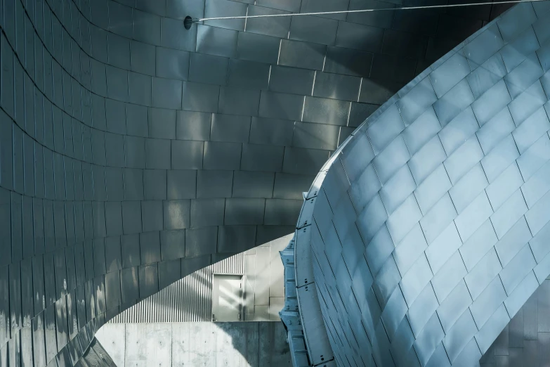 an aerial view of the underside of a curved, metal structure