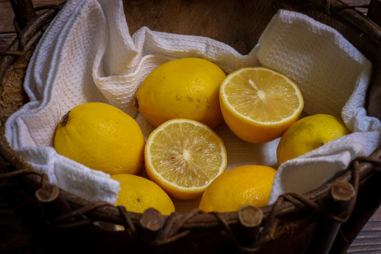 some lemons are in a bowl on the table