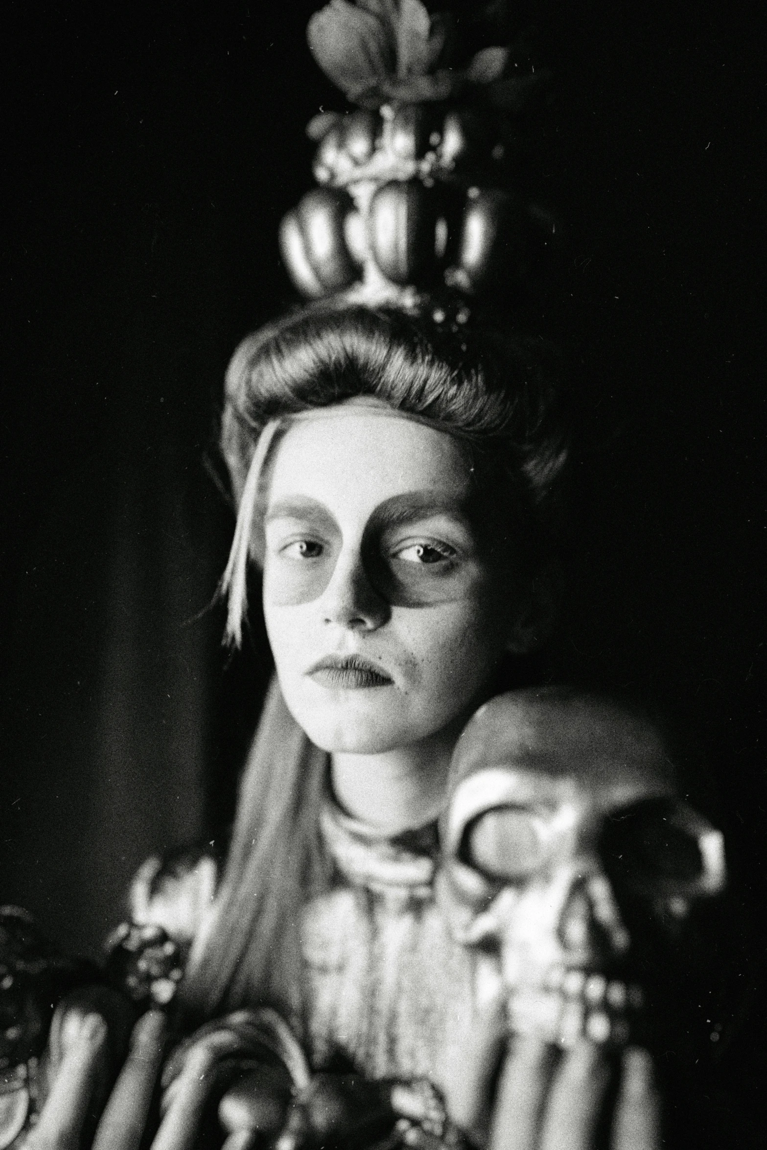 woman in elaborate costume holds a bird, vintage