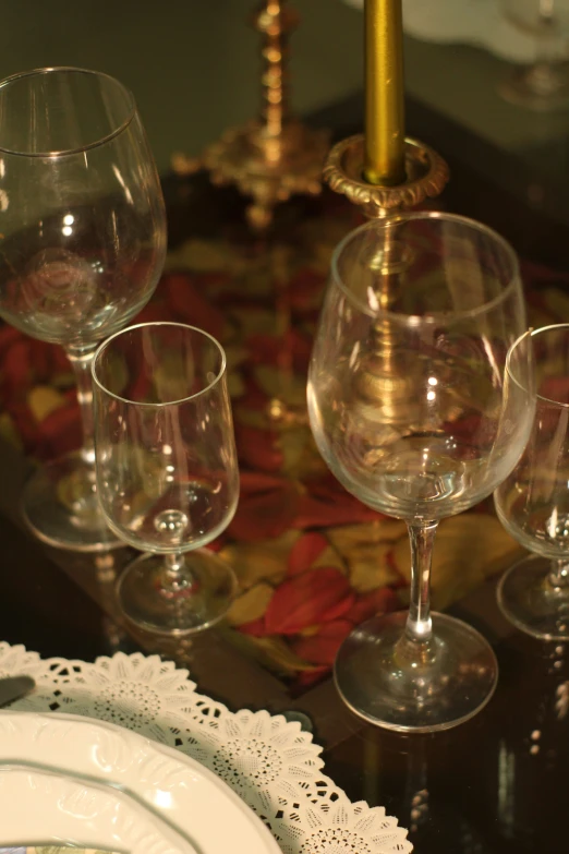 an assortment of wine glasses sitting on a table