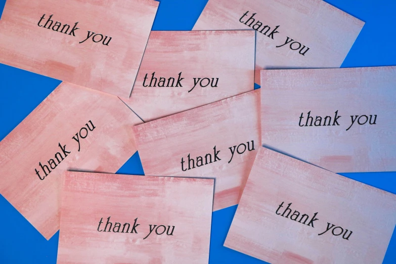 a group of pink thank you notes that say thank you