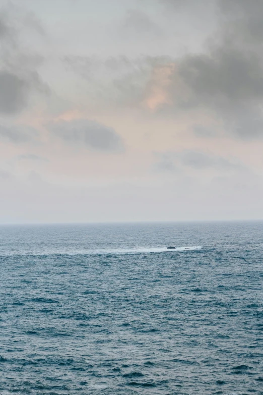 a lone boat in the middle of the ocean