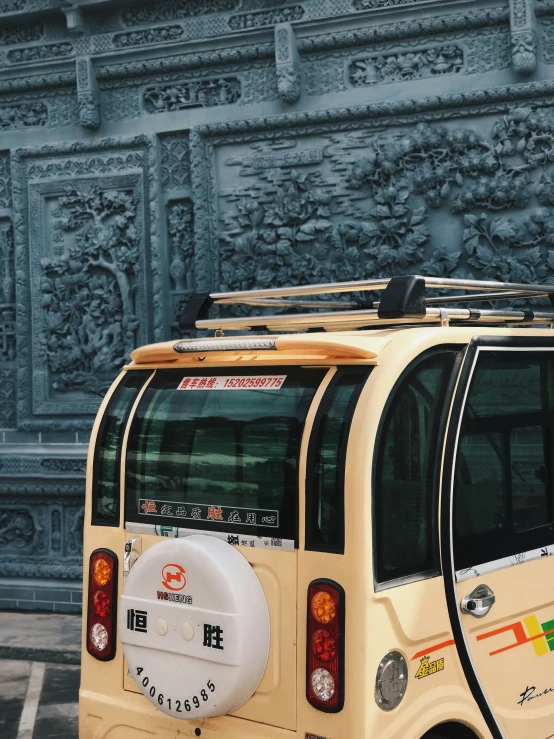 the side view of an old looking vehicle in the street