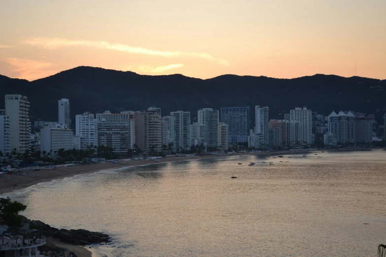 a city by the ocean with buildings at the bottom