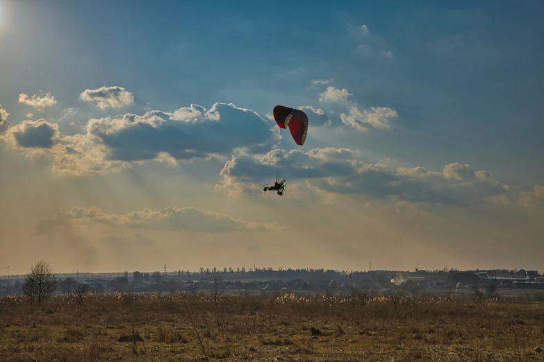 the parachute is flying in the cloudy sky