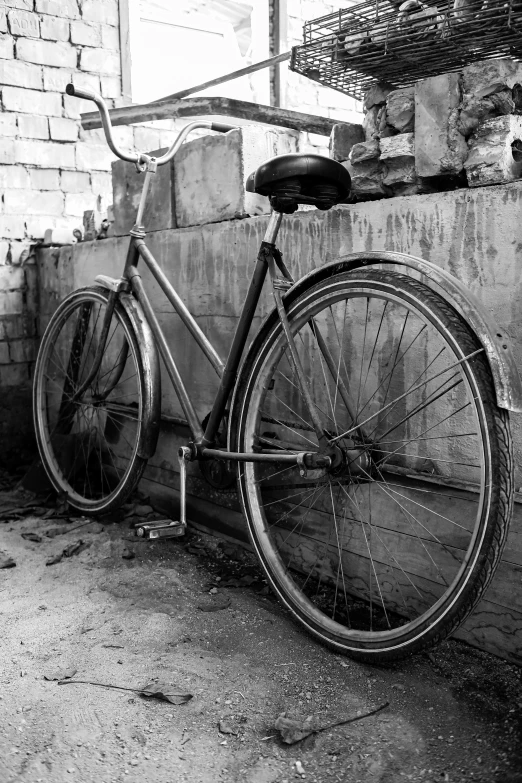 a bicycle parked next to a brick building