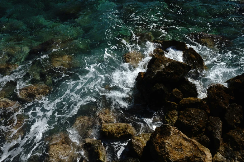 the view from above shows large rocks and small water waves