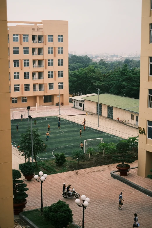 s play on an empty soccer court in the courtyard of a building