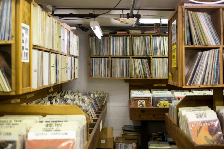 an extremely cluttered store with rows of records, dvds and albums