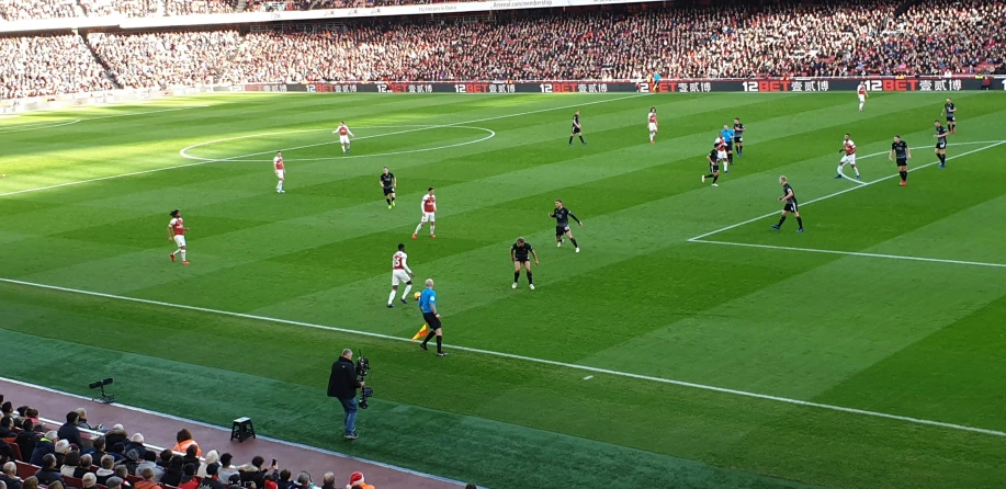 a soccer game with players running for the ball