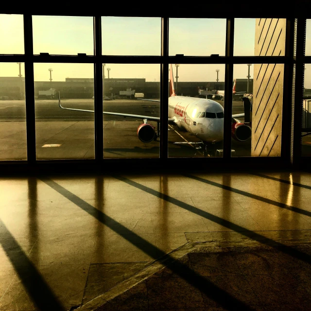 a plane sitting on the tarmac in a small airport