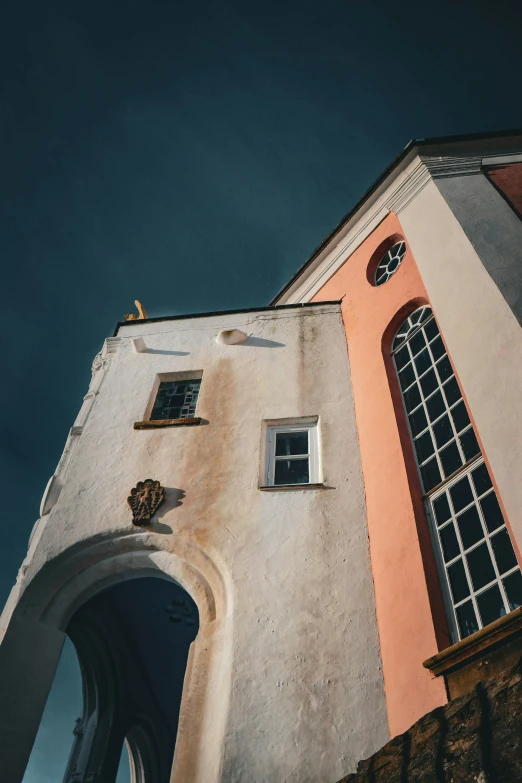 a tall white building with a clock on the front of it