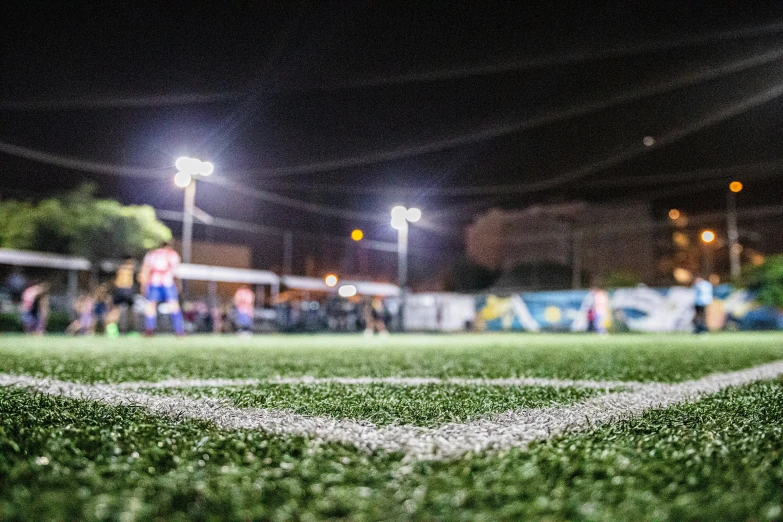 two players playing soccer at night during the game