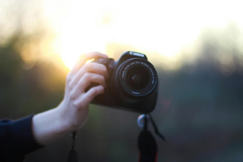 the sun is shining down behind a person's camera