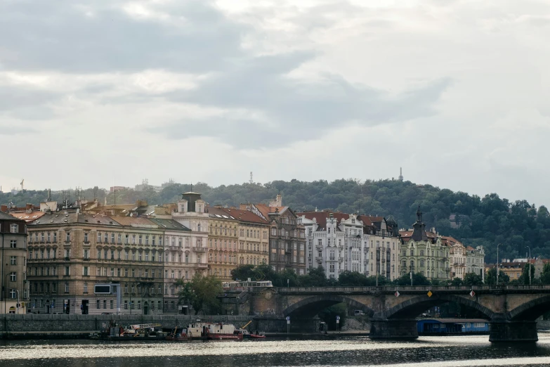 a city along the river and bridge in the foreground