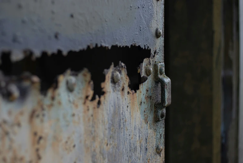 an old door has been scratched and has peeling paint on it