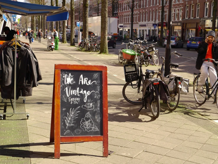 a chalkboard sign reads the age lunches on the sidewalk in front of bikes