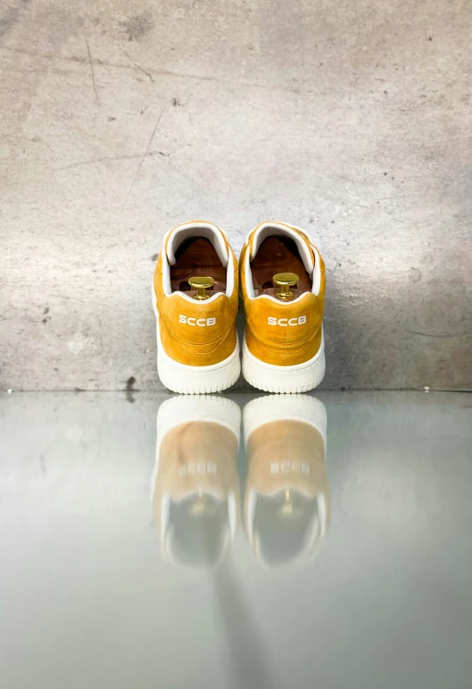 a pair of shoes sitting on top of a metal counter