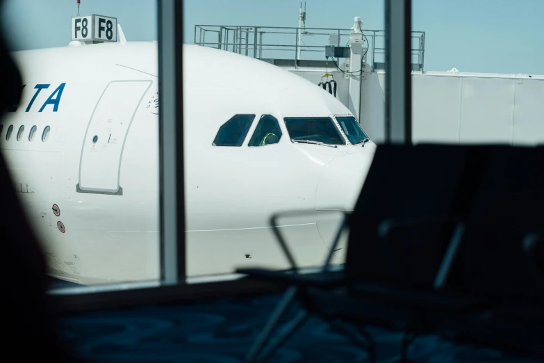 there are several chairs by the wing of a large airplane