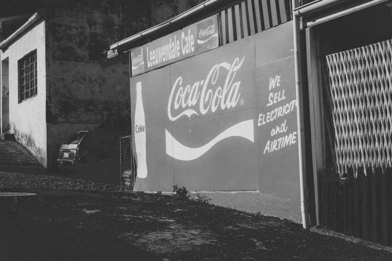 black and white pograph of coca cola signs on building