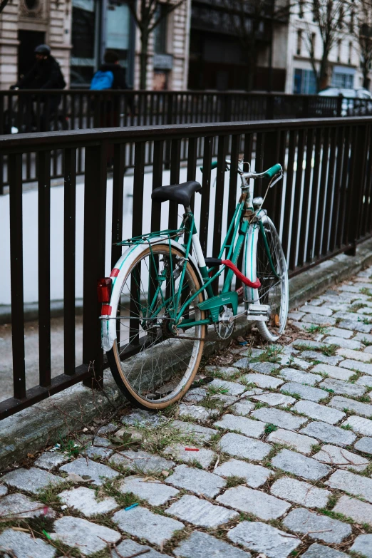 a bike that is propped up against a fence