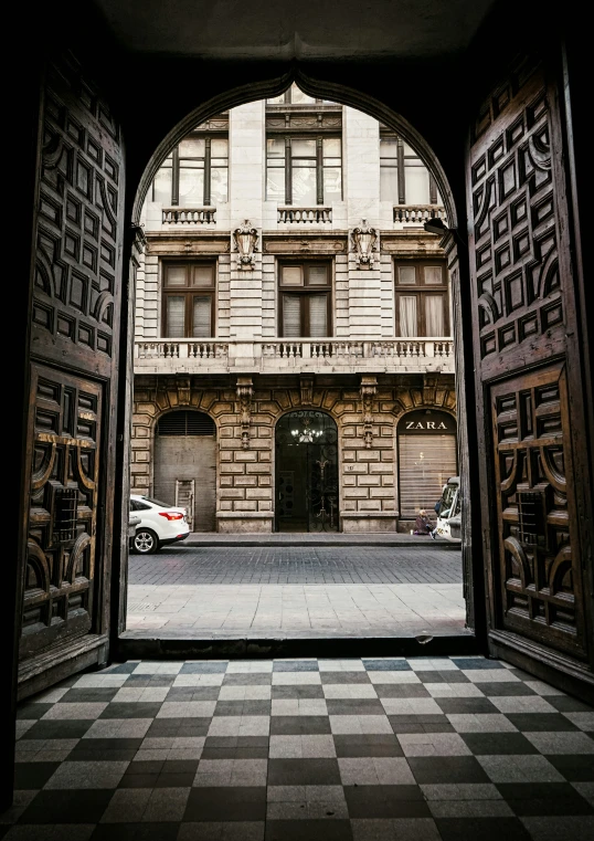 a city entrance with an open door to the inside