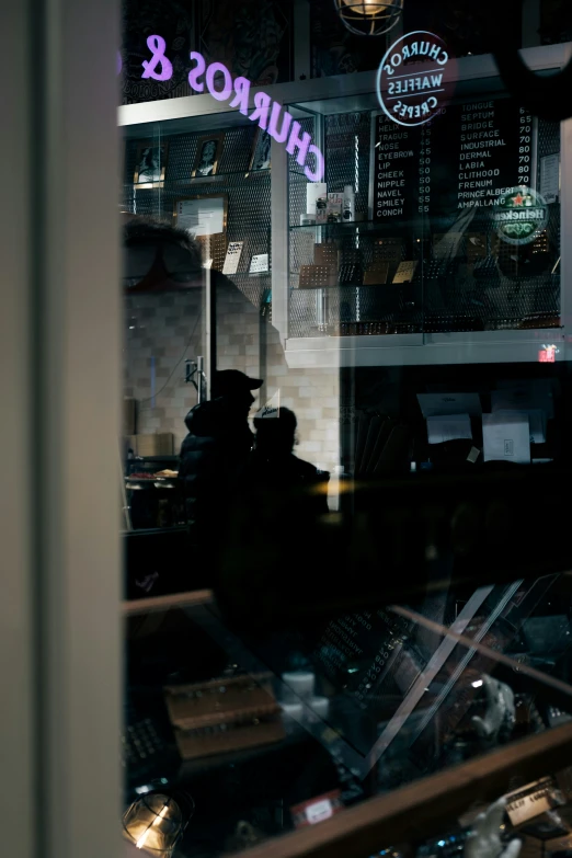 a shop with a window that has purple lettering on it