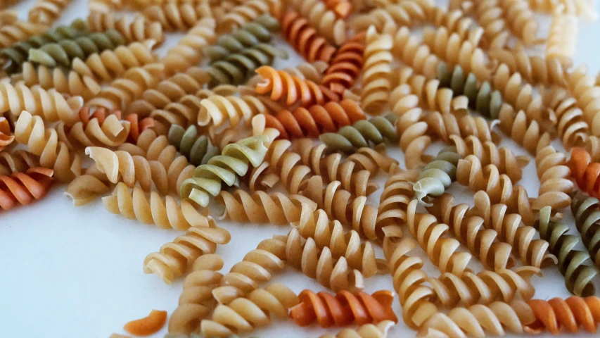 some pasta with several other ingredients all in a pile