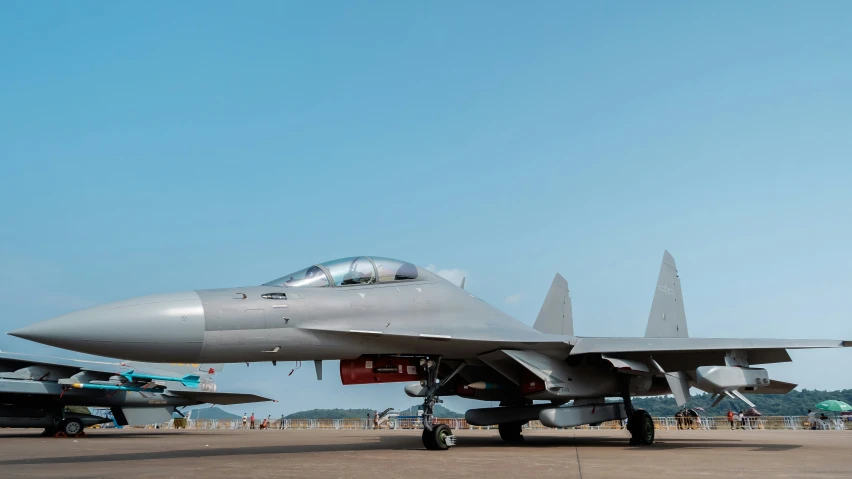 several jet fighters lined up at an airport