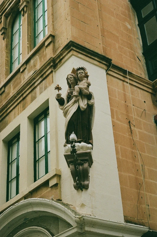 an intricate sculpture with many details adorns the side of a building