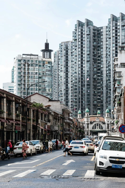 traffic and pedestrians in front of many tall buildings