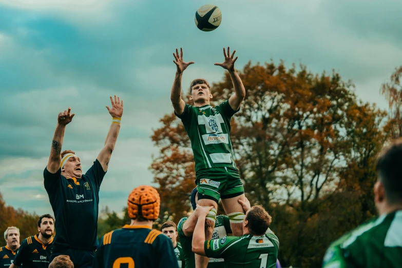 a man in the air with a ball near others