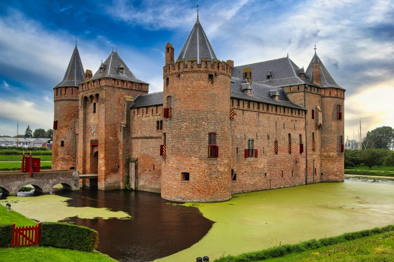 a very big old building by a lake