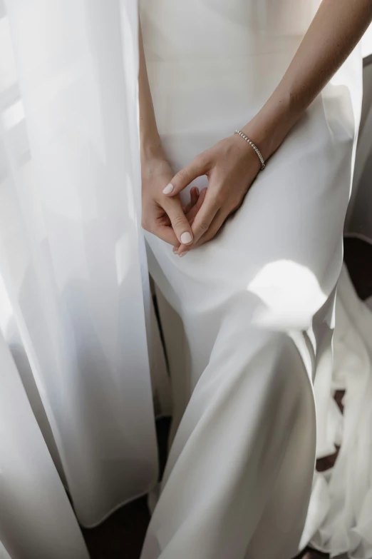 a person holding their wedding ring with both hands