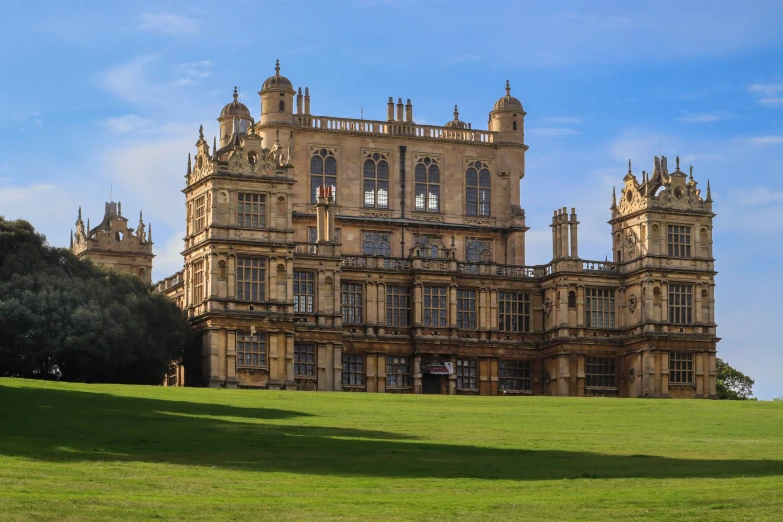 an old building is shown on top of a hill