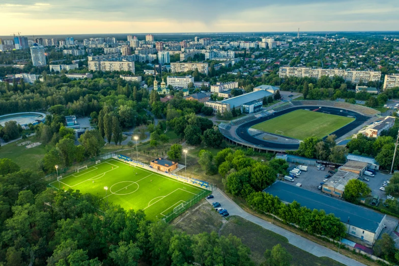 a cityscape with an aerial view of a soccer field