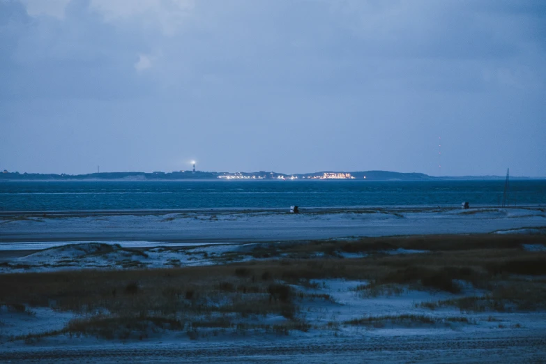 a boat sitting in the distance with land in the background