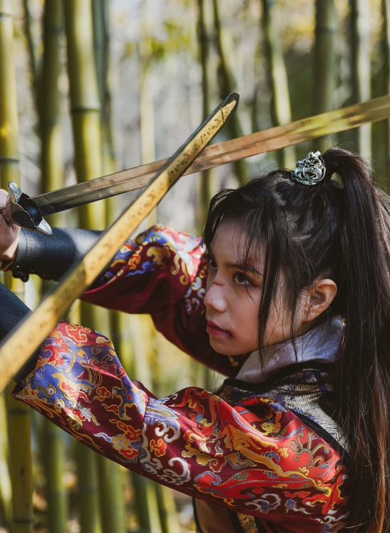 a woman is holding two swords in her hands