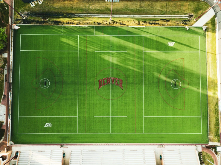 an aerial view of a tennis court and field