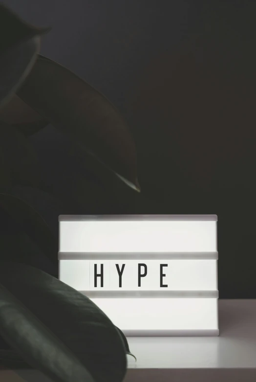 this is a sign with the words hyppe illuminated in a white light box