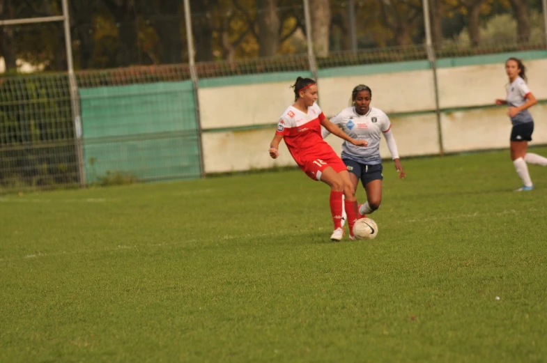 women in soccer uniforms running down the field