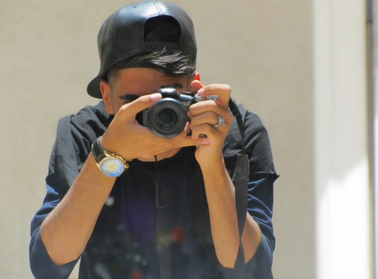 a young man taking pictures with his digital camera