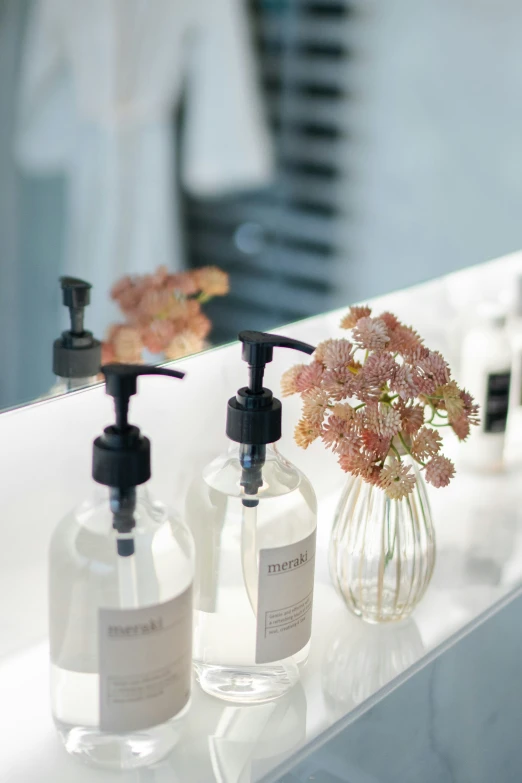 bottles of body wash sitting on a mirror counter