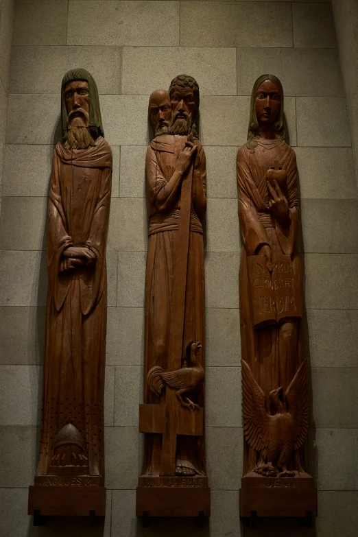 three statues that are hanging on the wall