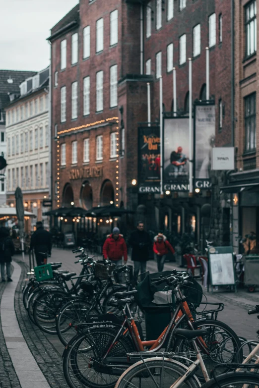 a bunch of bikes parked outside a store on the street